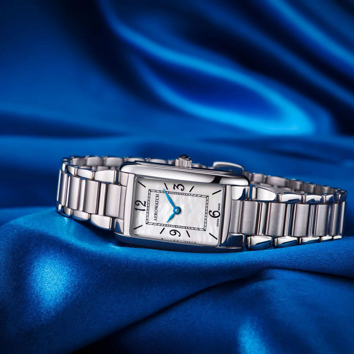 Aerowatch Mini Intuition Mother of Pearl watch lying on blue silk cloth