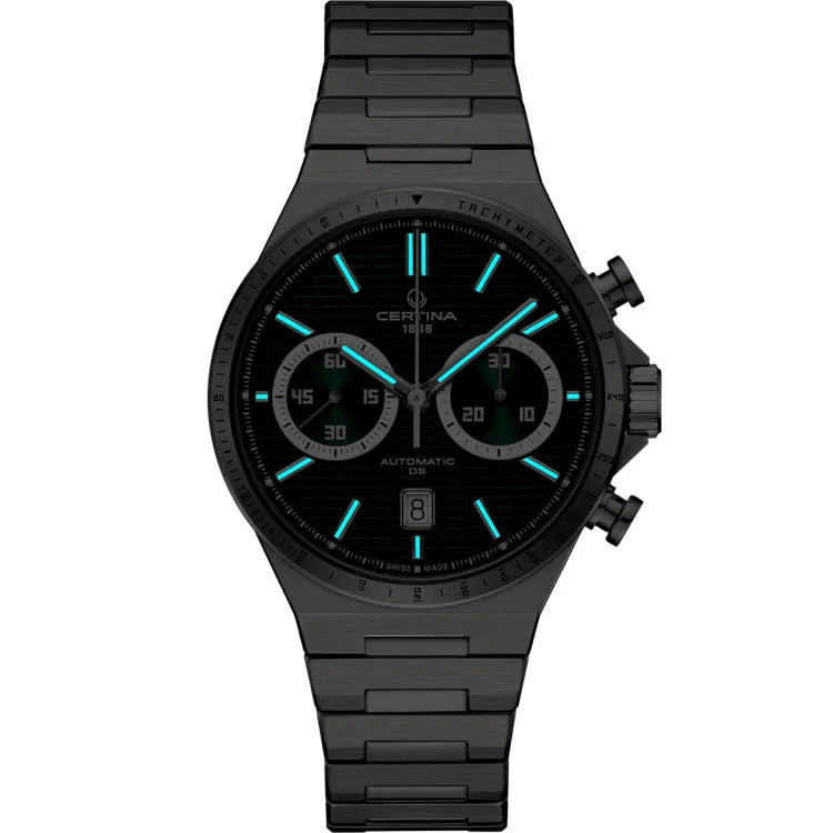 Certina DS-7 Chrono Auto C043.427.11.091.00 in a dark setting, highlighting its Super-LumiNova-coated hour markers and hands glowing in a vivid blue hue. The luminescent details ensure excellent readability in low-light conditions, while the polished stainless steel case and bracelet maintain a sleek, modern aesthetic.