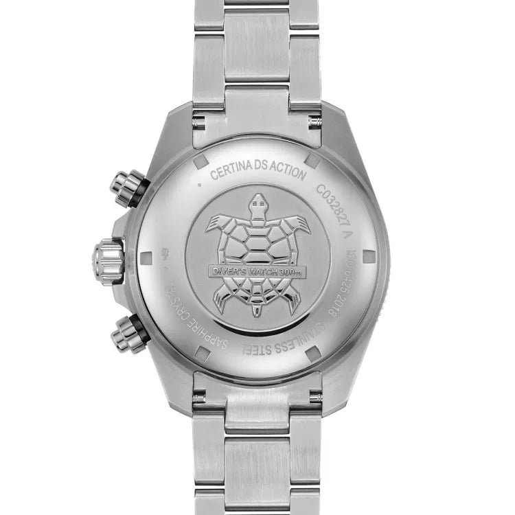 Back view of the Certina DS Action Diver Chrono featuring a stainless steel case back engraved with a turtle emblem and ‘Diver’s Watch 300m’ text. Surrounding engravings include ‘Certina DS Action,’ model reference ‘C032.827.A,’ ‘ISO 6425:2018,’ ‘Sapphire Crystal,’ and ‘Stainless Steel.’ The brushed stainless steel bracelet is attached, and the screw-down pushers and crown are visible on the left side. The polished and brushed surfaces enhance the watch’s rugged yet refined look, emphasizing its durability.