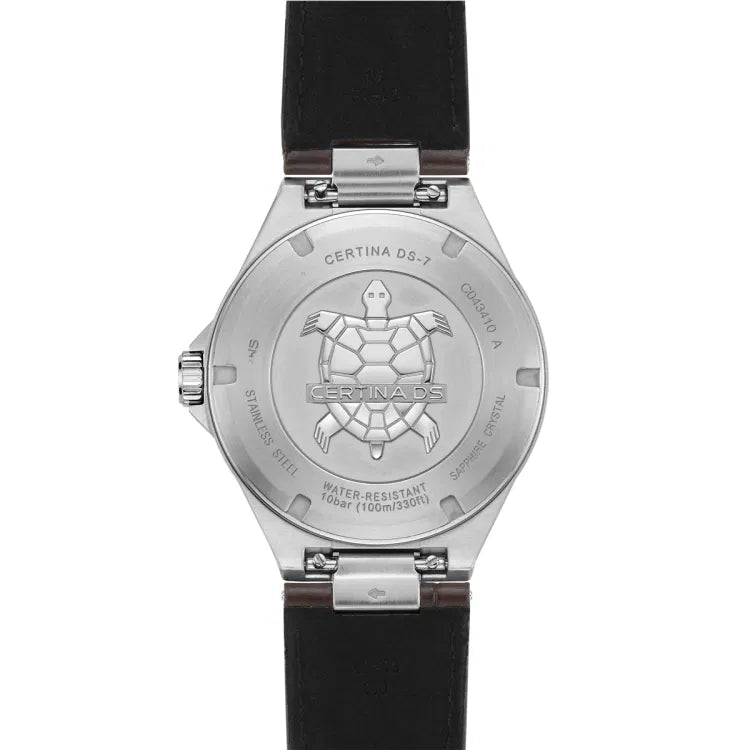 The back view of the Certina DS-7 Quartz watch, showcasing the stainless steel case back with an embossed turtle emblem, a signature symbol of Certina’s durability. The engraved text around the case back includes the model name "Certina DS-7," reference number "C043.410 A," and details about the watch's construction, such as "Stainless Steel," "Sapphire Crystal," and its water resistance rating of "10 bar (100m/330ft)." The dark leather strap is visible at the top and bottom, attached v