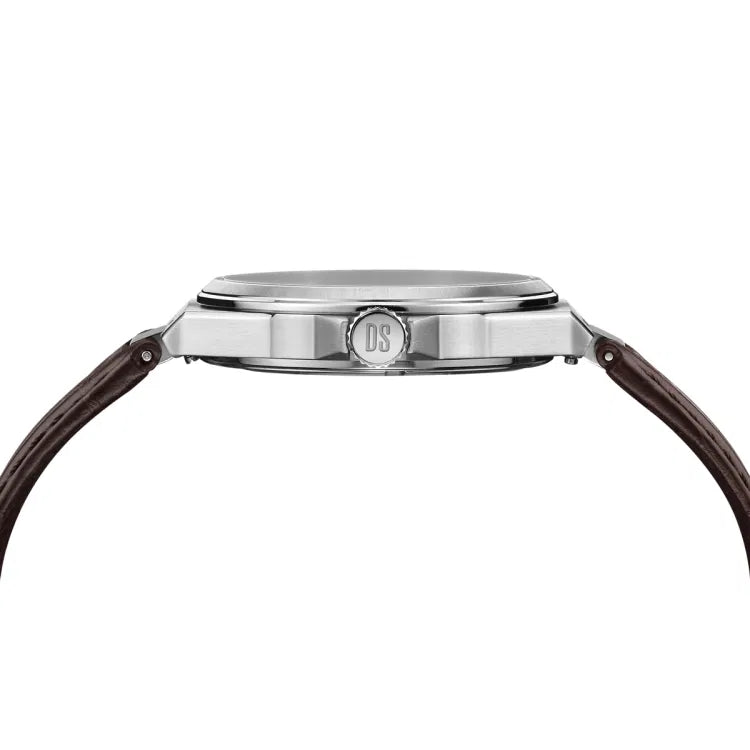 Side profile view of the Certina DS-7 Quartz watch (C043.410.16.031.00), showcasing its slim 316L stainless steel case with a polished finish. The crown, engraved with the "DS" logo, is positioned at the center. The dark brown leather strap with visible stitching attaches seamlessly to the lugs, highlighting the watch’s elegant design. The sapphire crystal is slightly raised, adding to the refined aesthetic.