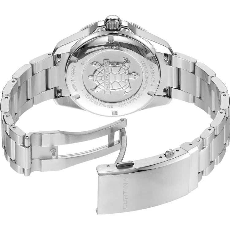 Angled view of the Certina DS Action Diver 40.5mm watch with the stainless steel bracelet fully open, revealing the engraved case back with a turtle emblem and “DIVER’S WATCH 300m” inscription. Surrounding engravings include “C048407 A,” “CERTINA DS ACTION,” “ISO 6425:2018,” “SAPPHIRE CRYSTAL,” “STAINLESS STEEL,” and “SWISS AUTOMATIC.” The clasp is engraved with the Certina logo and shows the diver extension mechanism.