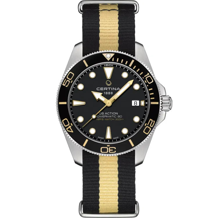 Front view of the Certina DS Action Diver 40.5mm watch with a black and beige NATO strap, black ceramic bezel with gold-tone markings, and a black dial featuring luminous indices and hands. Visible inscriptions include “CERTINA 1888,” “DS ACTION,” “POWERMATIC 80,” and “DIVER’S WATCH 300m.” A date window is shown at the 3 o’clock position.