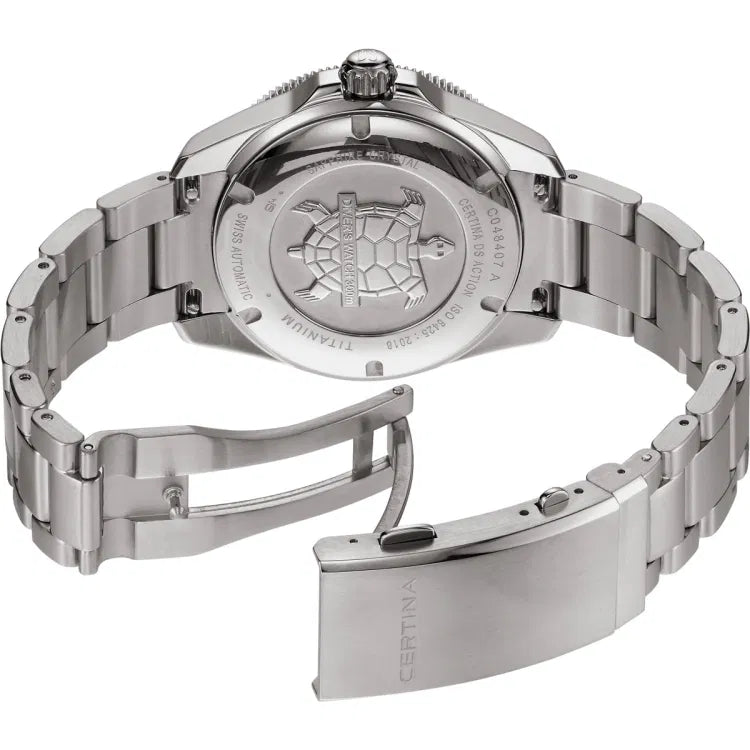 Angled view of the Certina DS Action Diver 40.5mm watch with titanium case and bracelet shown open to reveal the engraved case back. The turtle emblem is centered with “DIVER’S WATCH 300m” inscription, surrounded by text including “CERTINA DS ACTION,” “C048407 A,” “ISO 6425:2018,” “TITANIUM,” “SWISS AUTOMATIC,” and “SAPPHIRE CRYSTAL.” The clasp is engraved with the Certina logo and shows the diver extension mechanism.