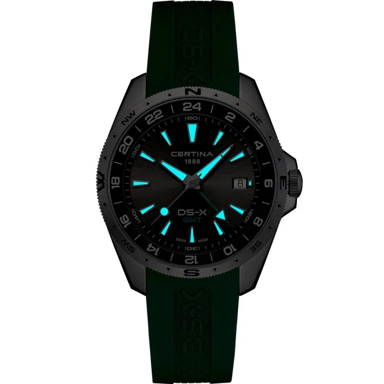 certina ds-x gmt c047.452.17.081.00 night view with glowing superluminova hands and indices, black dial, green rubber strap, certina 1888 and ds-x gmt logos, swiss made label visible at 6 o’clock