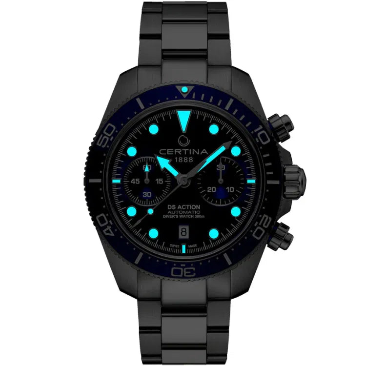 Front view of the Certina DS Action Diver Chrono in a dark setting, showcasing its luminescent features. The blue Super-LumiNova-coated hands and hour markers glow brightly, ensuring readability in low-light conditions. The dial features 'Certina 1888' below 12 o’clock and 'DS Action Automatic Diver’s Watch 300m' above 6 o’clock. The unidirectional ceramic bezel with a 60-minute scale is faintly visible, while the chronograph subdials at 9 and 3 o’clock maintain their functional display.